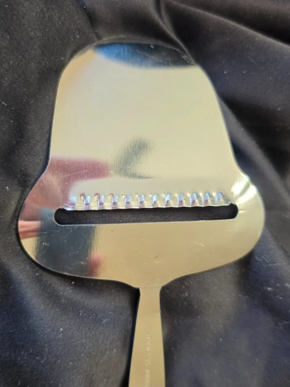 Stainless cheese slicer with fruit/leaf covered nicely weighted handle-kitchen